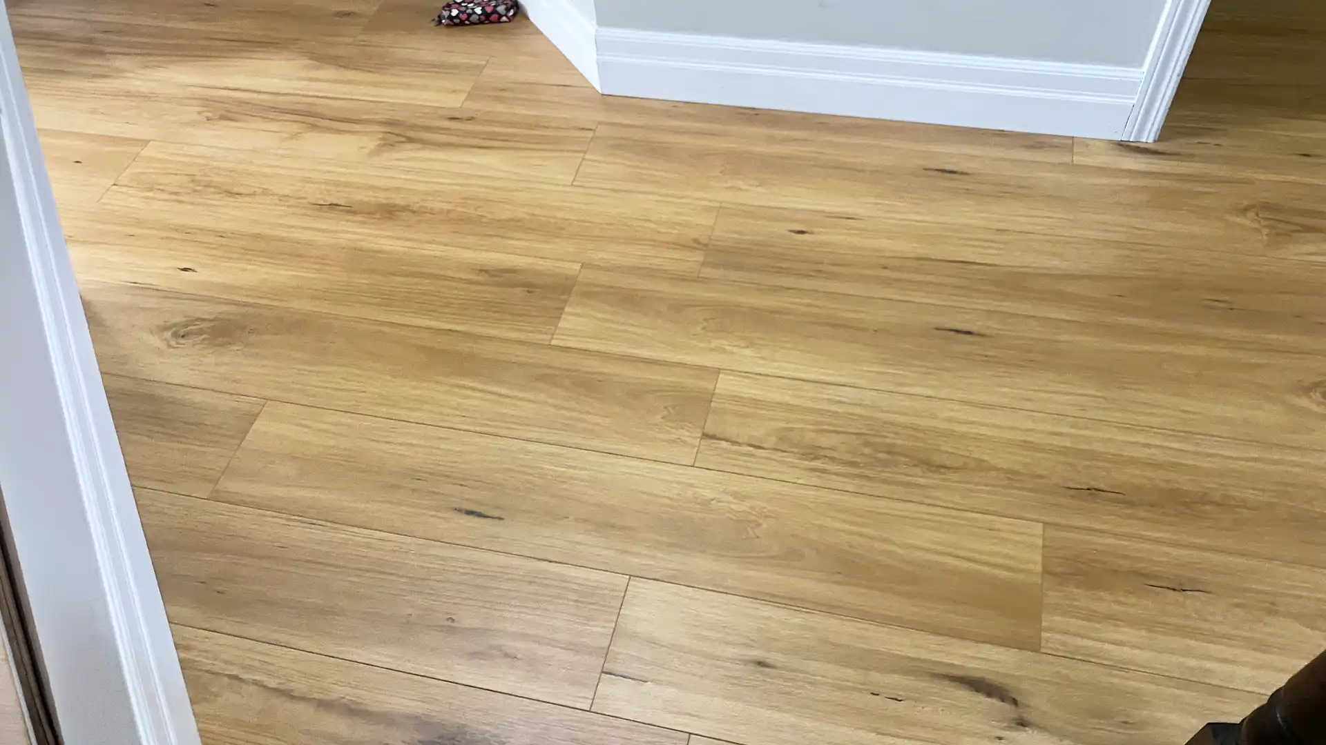 Premium Laminate Flooring Installation with Hardwood Stairs in a Residential Home by Petun Flooring