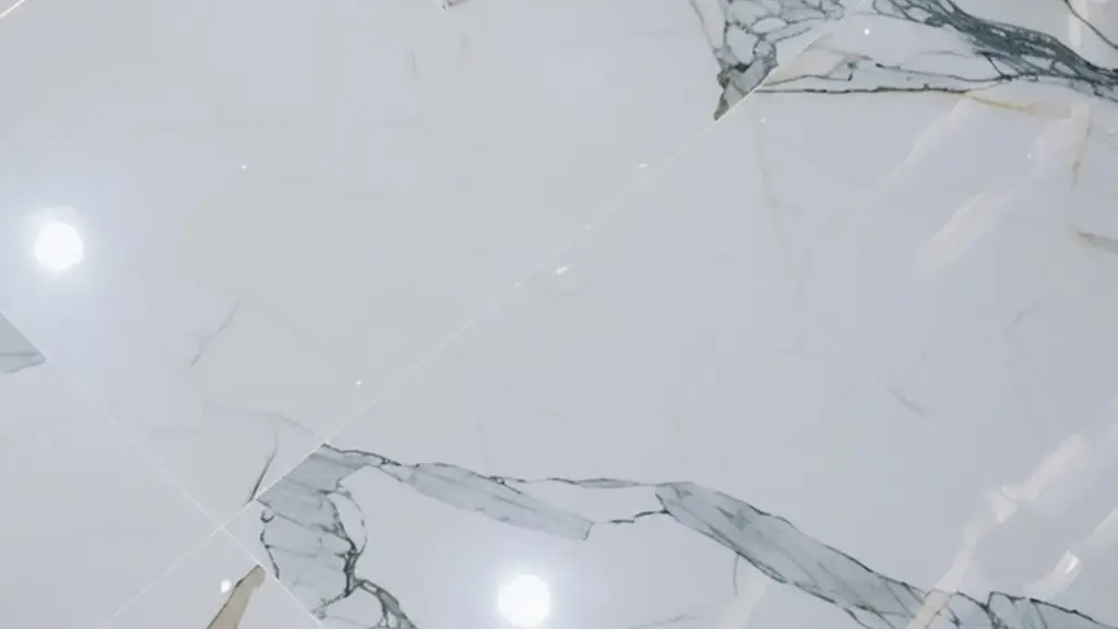 Glossy white marble-look ceramic tile floor before a vinyl plank installation