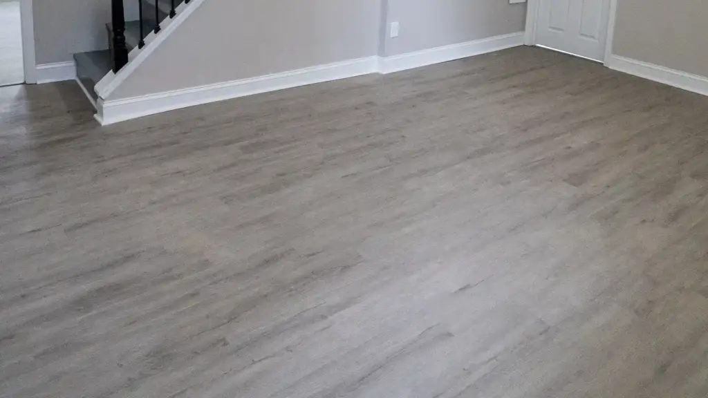 Waterproof vinyl plank flooring for basements in a finished grey oak lower level in Ontario